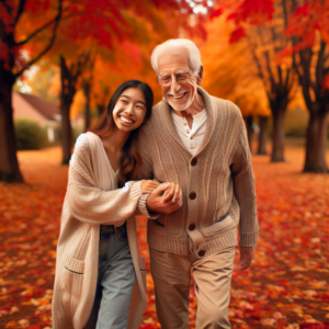 A couple of different ages happily walking in a park during autumn, leaves falling around them, showing a strong emotional connection despite age difference.